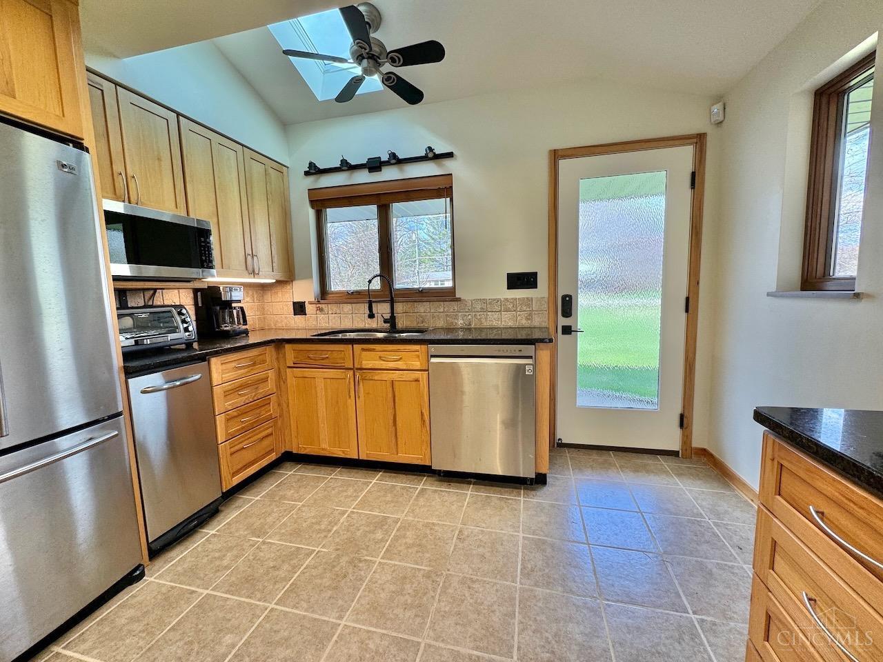 7877 State Road Cincinnati, OH 45255 - Photo 15 of 54 Kitchen features granite counters, wood cabinets, stainless steel appliances plus ceiling fan and sink with sprayer