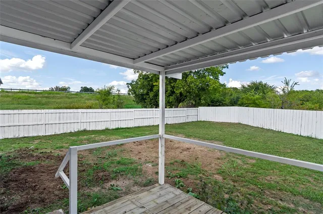 a view of a backyard with pathway