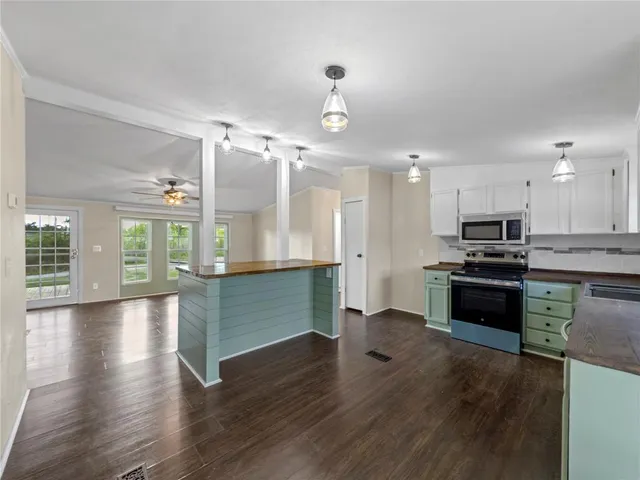 a view of kitchen with sink and refrigerator