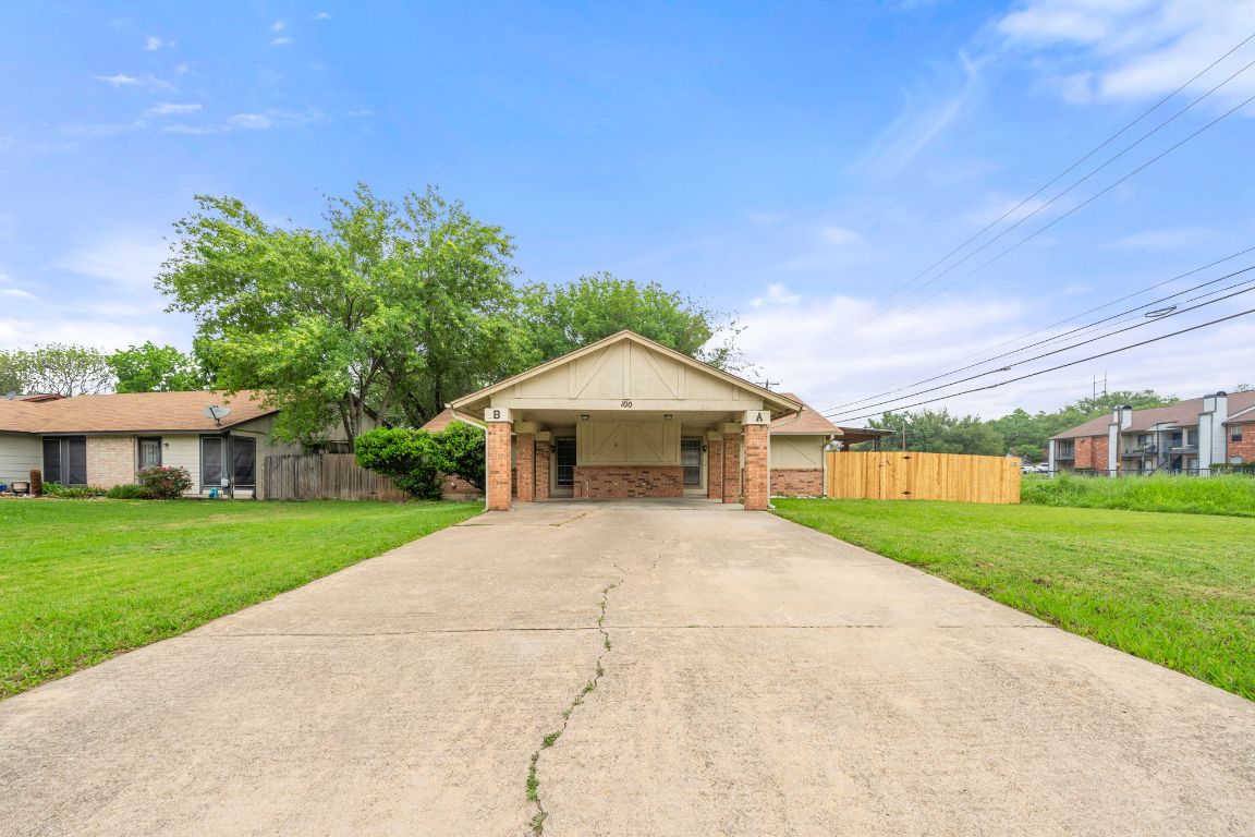 View of front of home featuring concrete driveway and brick siding