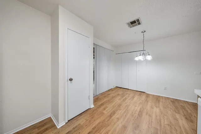 a kitchen with stainless steel appliances granite countertop a refrigerator a stove and a wooden floors