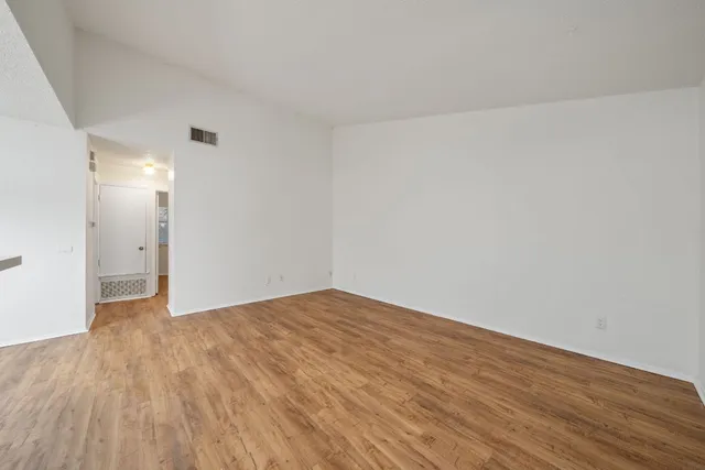 a view of an empty room and wooden floor