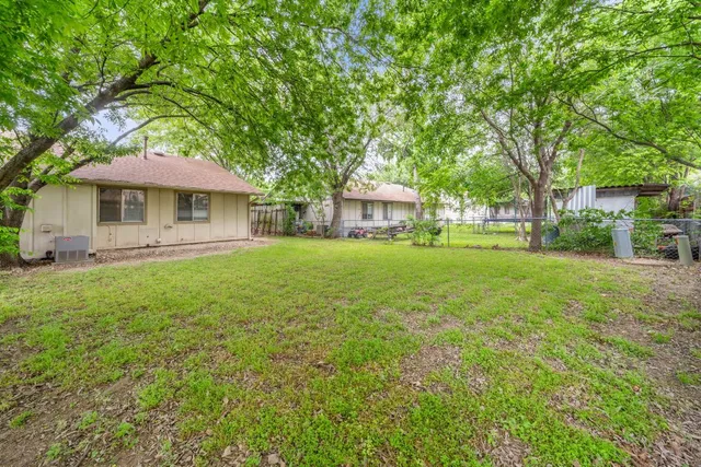 a house view with swimming pool in front of it