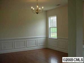5402-1 Griffith Road Monroe, NC 28112 - Photo 4 of 8 wooden floor in an empty room with a window