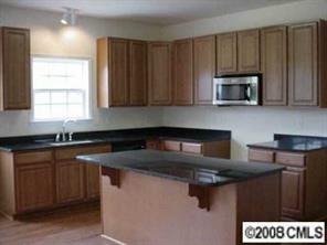 5402-1 Griffith Road Monroe, NC 28112 - Photo 5 of 8 a kitchen with stainless steel appliances granite countertop a sink stove and microwave