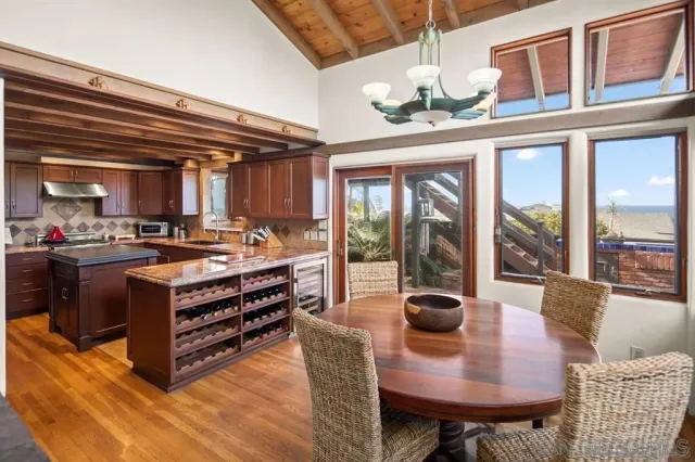 a view of a dining room with furniture wooden floor and chandelier
