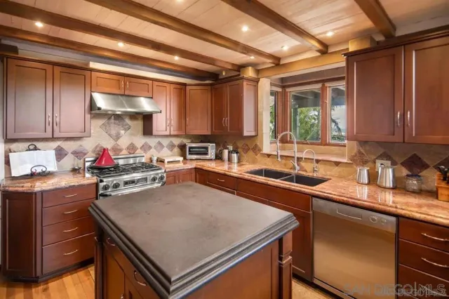 a kitchen with a stove a sink and a refrigerator