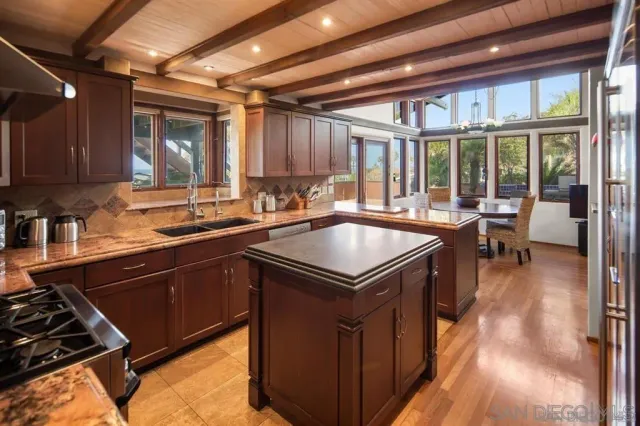 a kitchen with a sink appliances and cabinets