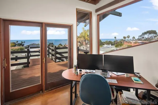 a view of a balcony with chairs and wooden floor