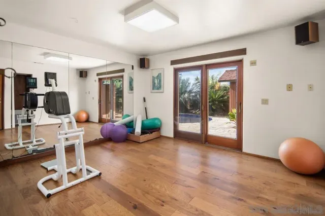 a view of a building with sitting area and potted plants