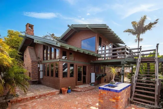 a white house with a large window and wooden floor