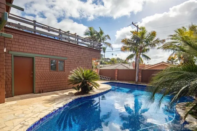 an aerial view of a house with a yard and garden