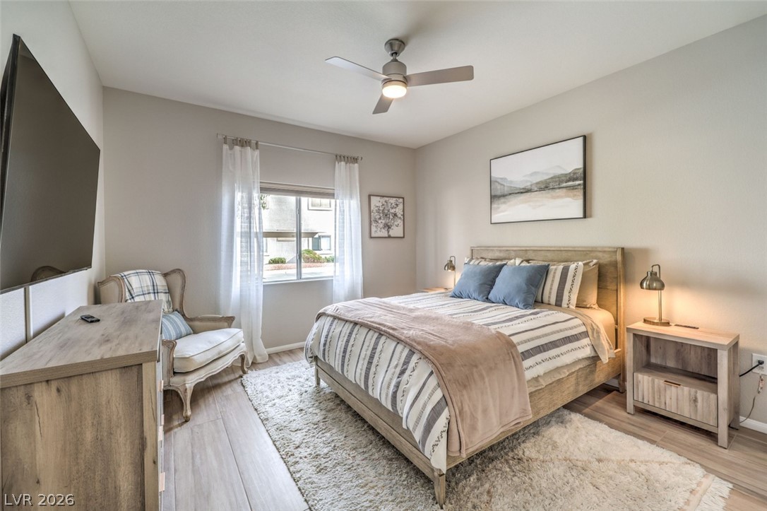 855 North Stephanie Street, Unit 1015 Henderson, NV 89014 - Photo 13 of 27 Bedroom is designed for relaxation with natural light & blackout shades for restful sleep w/ ceiling fan & light