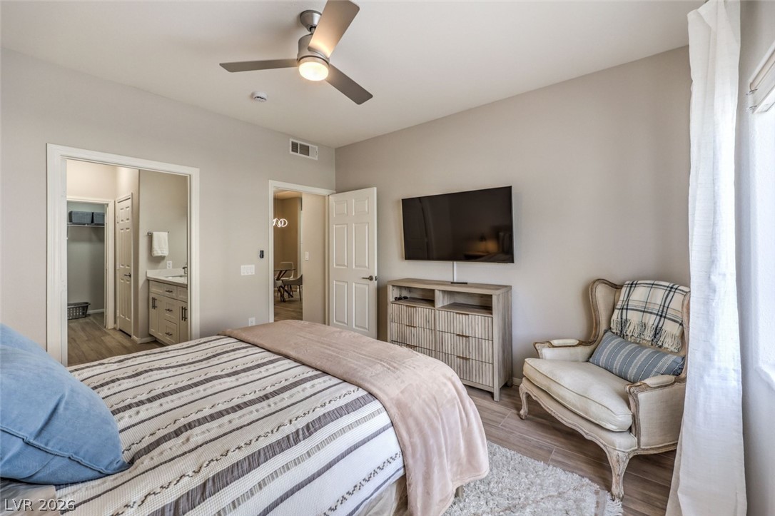 855 North Stephanie Street, Unit 1015 Henderson, NV 89014 - Photo 14 of 27 Bedroom is designed for relaxation with natural light & blackout shades for restful sleep w/ ceiling fan & light