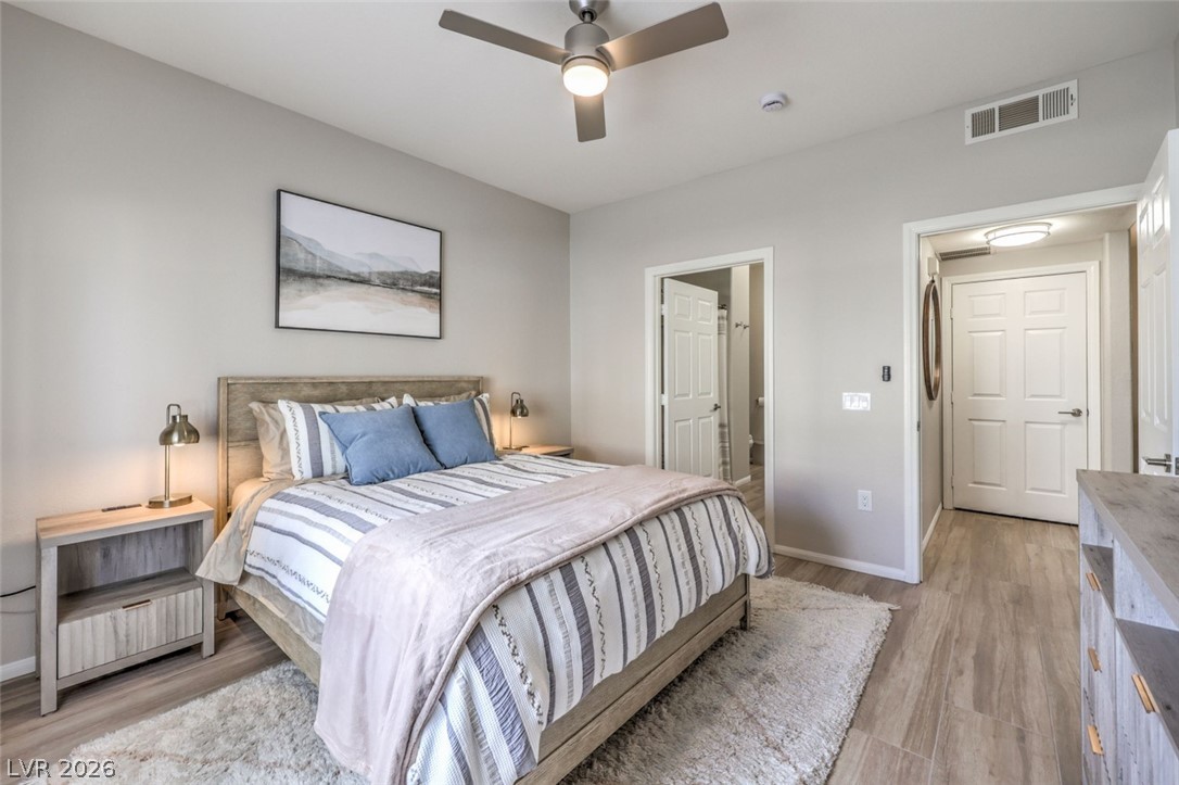 855 North Stephanie Street, Unit 1015 Henderson, NV 89014 - Photo 15 of 27 Bedroom is designed for relaxation with natural light & blackout shades for restful sleep w/ ceiling fan & light