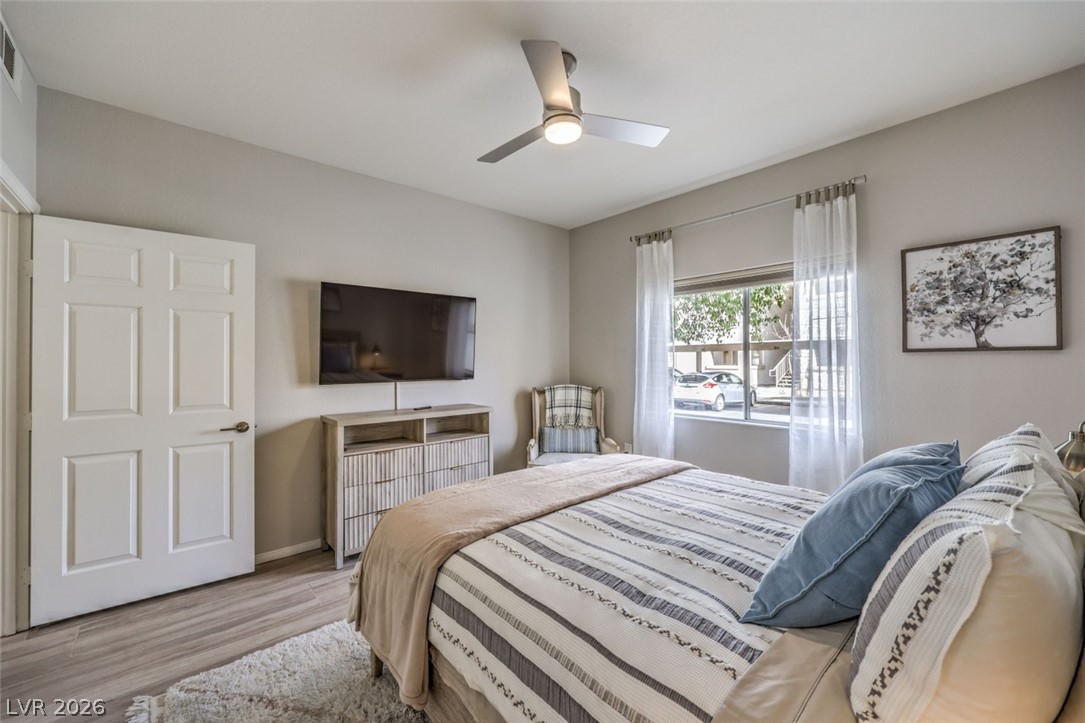855 North Stephanie Street, Unit 1015 Henderson, NV 89014 - Photo 16 of 27 Bedroom is designed for relaxation with natural light & blackout shades for restful sleep w/ ceiling fan & light