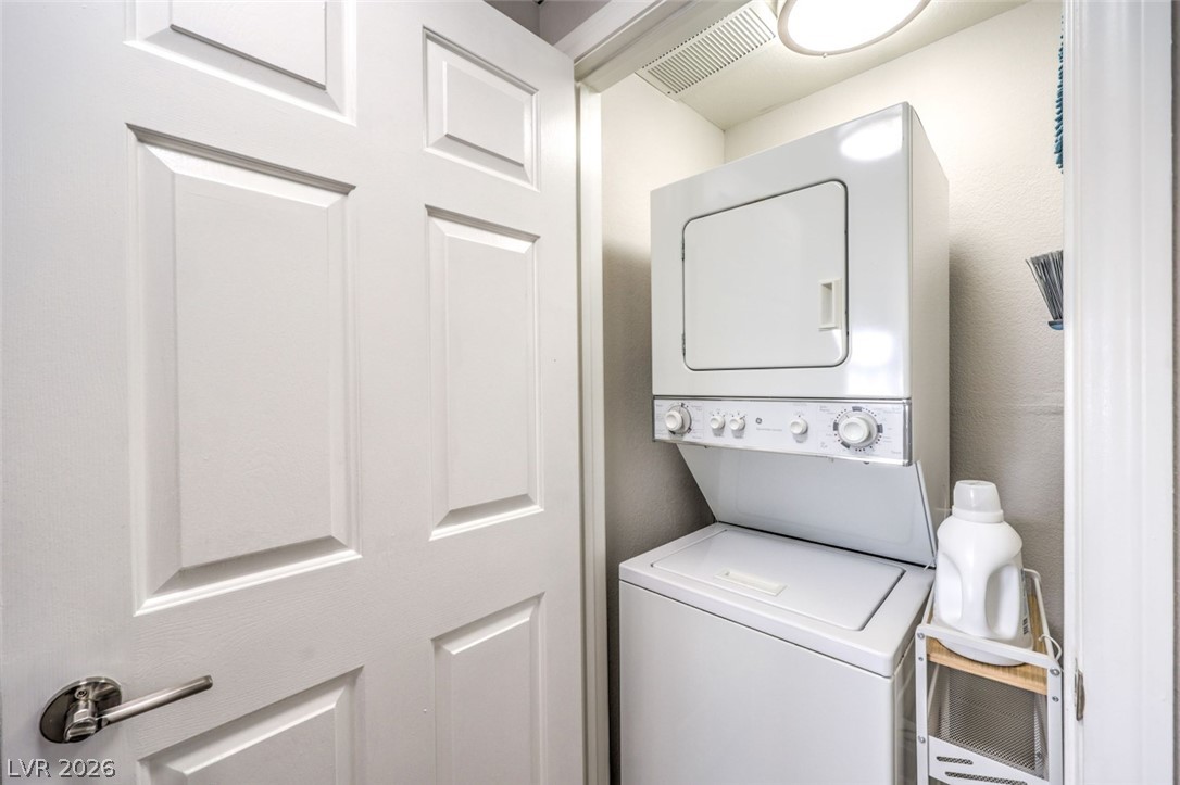 855 North Stephanie Street, Unit 1015 Henderson, NV 89014 - Photo 19 of 27 Laundry area with laundry area, stacked washer / dryer, and visible vents