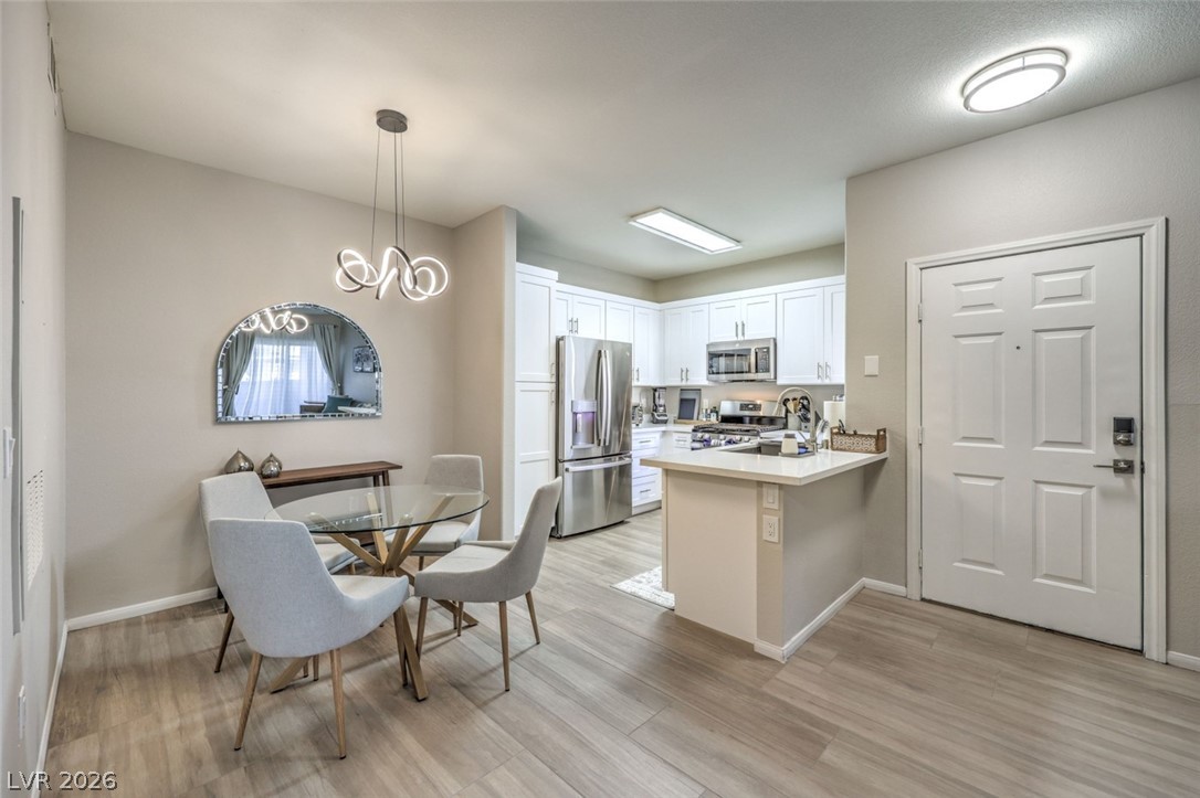 855 North Stephanie Street, Unit 1015 Henderson, NV 89014 - Photo 5 of 27 Kitchen boasts breakfast bar w/quaetz counters, white shaker cabinets w/soft close drawers & doors, stainless steel appliances, dining nook & pantry.