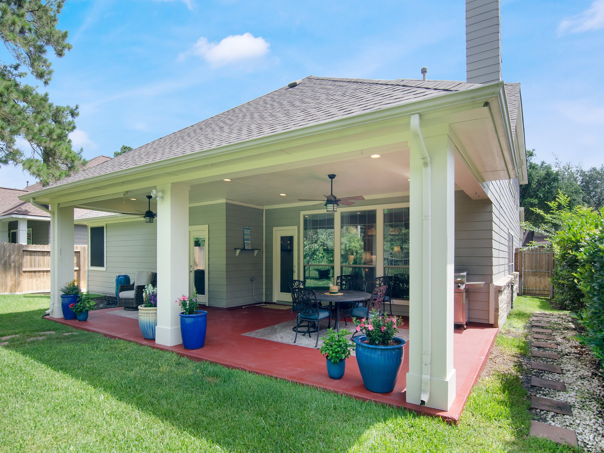 28323 Ryans Ridge Lane Spring, TX 77386 - Photo 36 of 45 Expansive covered patio offers plenty of space for outdoor dining, grilling and relaxing, complete with recessed lighting, ceiling fans and an attractive wrought-iron fence.