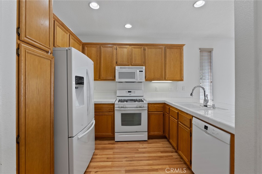 17887 Lilac Court Carson, CA 90746 - Photo 11 of 48 a kitchen with stainless steel appliances granite countertop a refrigerator and a sink