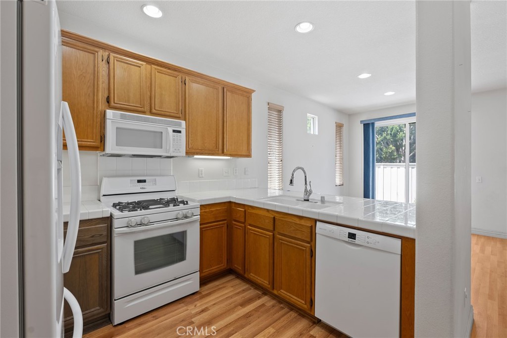 17887 Lilac Court Carson, CA 90746 - Photo 12 of 48 a kitchen with a sink stove and cabinets