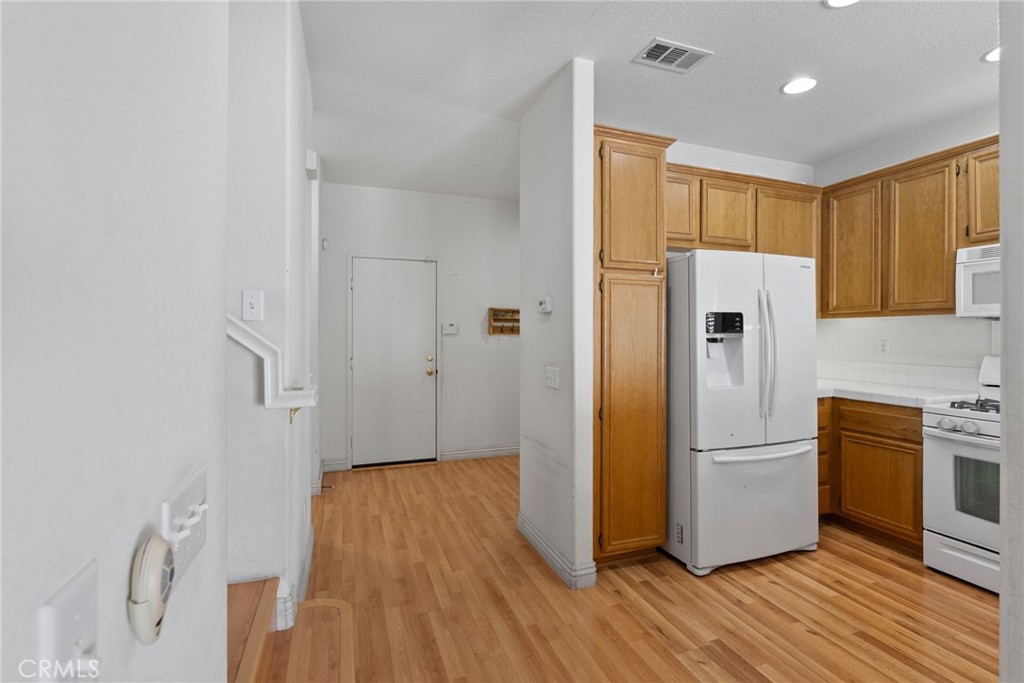 17887 Lilac Court Carson, CA 90746 - Photo 15 of 48 a kitchen with a refrigerator a sink and wooden floor