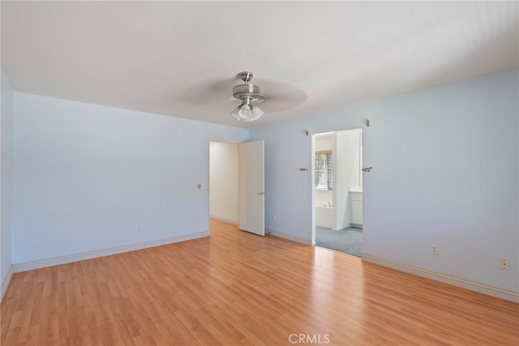 17887 Lilac Court Carson, CA 90746 - Photo 24 of 48 a view of an empty room with wooden floor and a ceiling fan