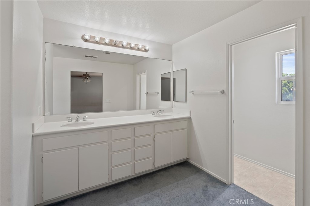 17887 Lilac Court Carson, CA 90746 - Photo 25 of 48 a spacious bathroom with a double vanity sink and mirror