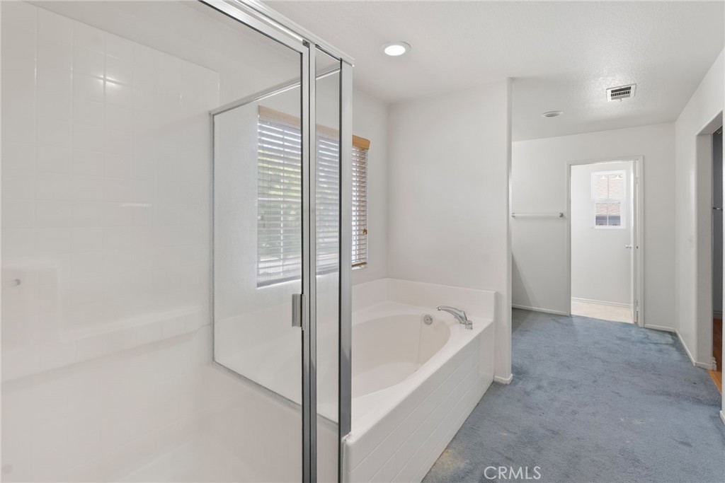17887 Lilac Court Carson, CA 90746 - Photo 27 of 48 a bathroom with a bathtub and a shower