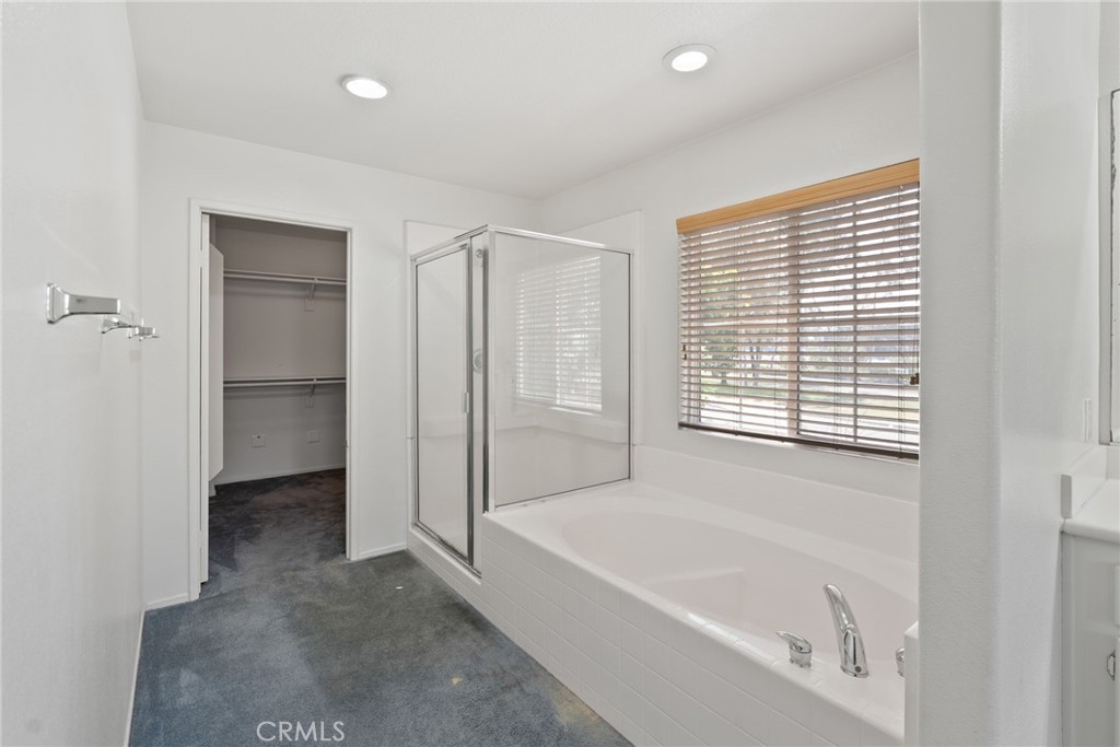 17887 Lilac Court Carson, CA 90746 - Photo 28 of 48 a bathroom with a bathtub and a shower