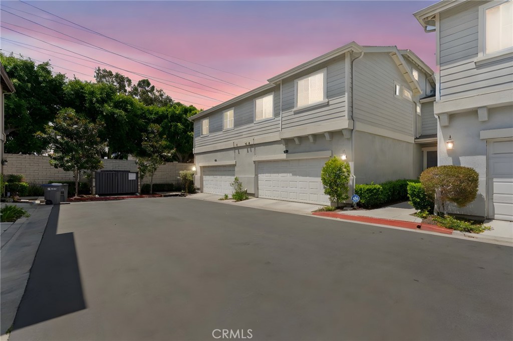 17887 Lilac Court Carson, CA 90746 - Photo 4 of 48 a front view of a house with a yard and garage