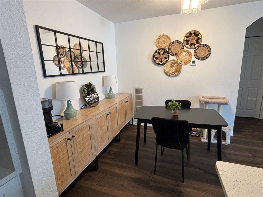8809 Manor Loop, Unit 202 Lakewood Ranch, FL 34202 - Photo 5 of 13 a view of a dining room with furniture and wooden floor