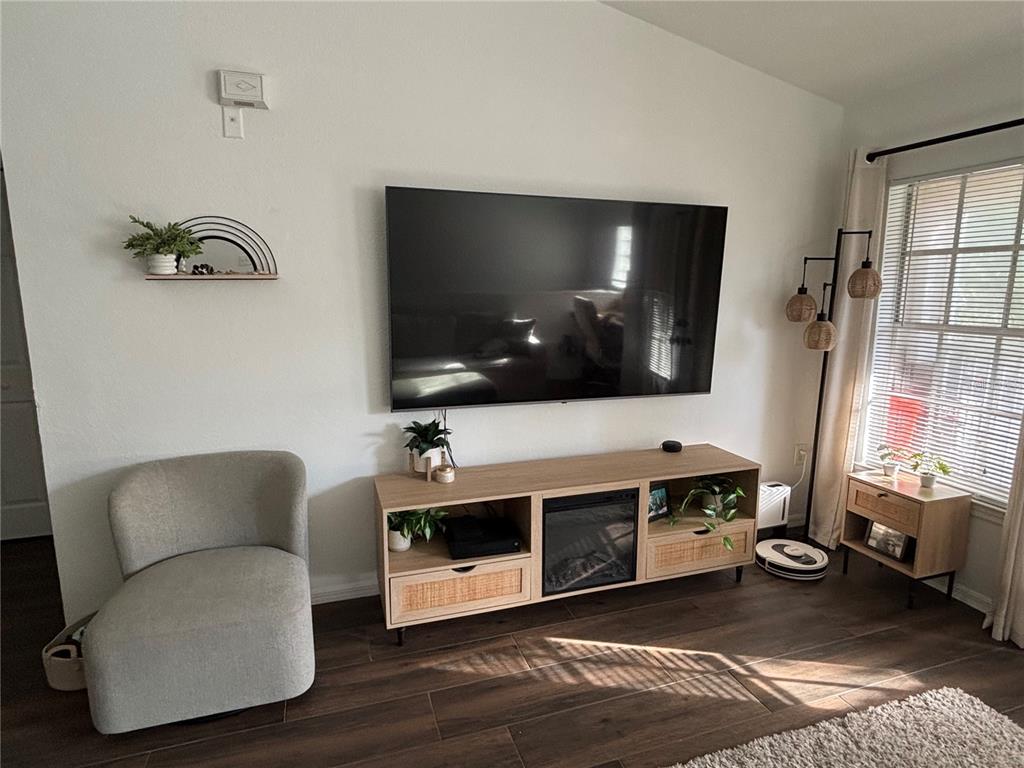 8809 Manor Loop, Unit 202 Lakewood Ranch, FL 34202 - Photo 7 of 13 a living room with furniture and a flat screen tv