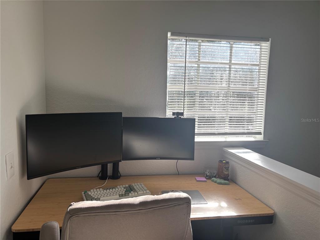 8809 Manor Loop, Unit 202 Lakewood Ranch, FL 34202 - Photo 8 of 13 a living room with a couch and a window