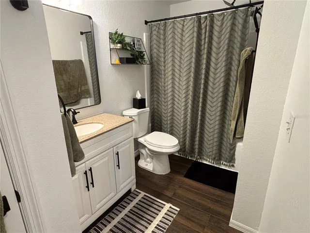 a bathroom with a shower and a sink