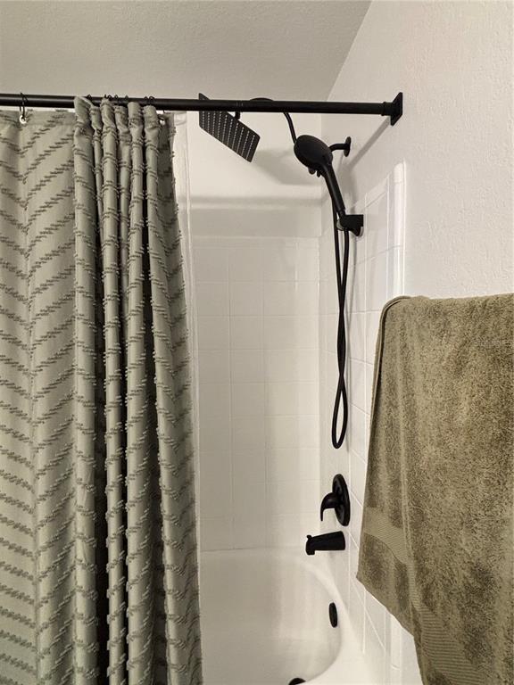 8809 Manor Loop, Unit 202 Lakewood Ranch, FL 34202 - Photo 10 of 13 a bathroom with a shower and a sink