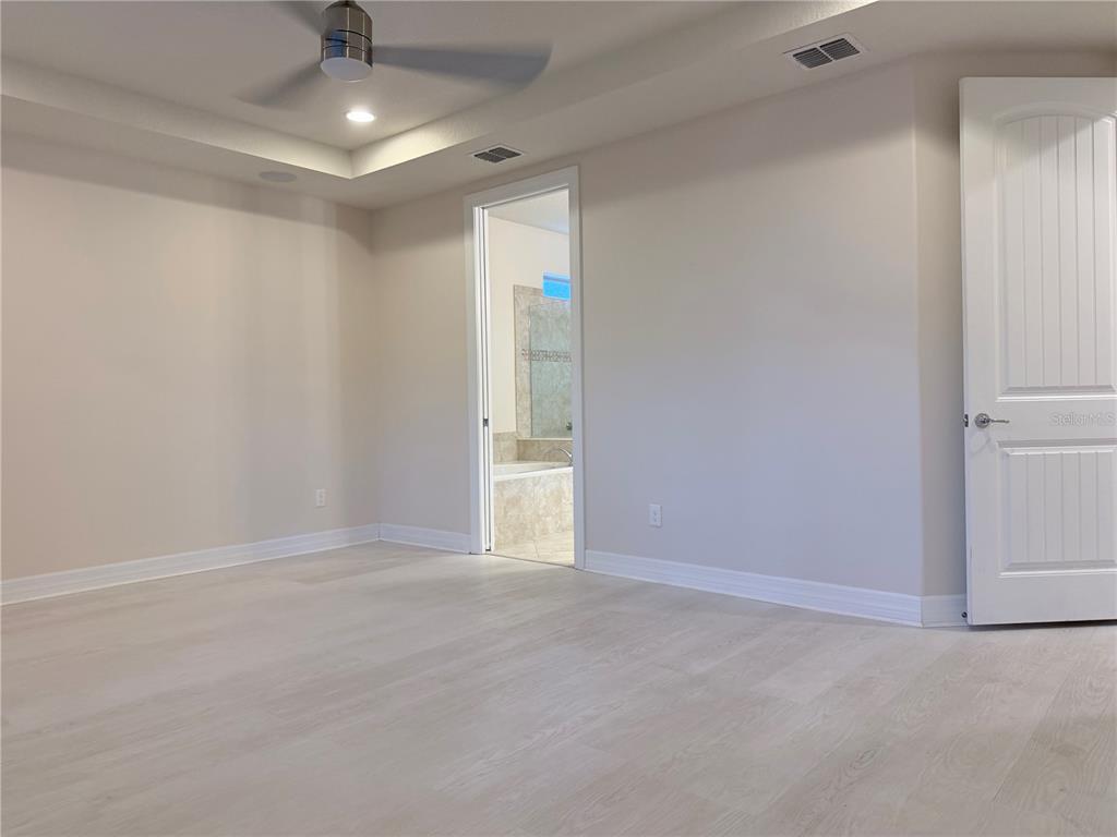 10041 Southwest 77th Loop Ocala, FL 34481 - Photo 17 of 39 wooden floor in an empty room