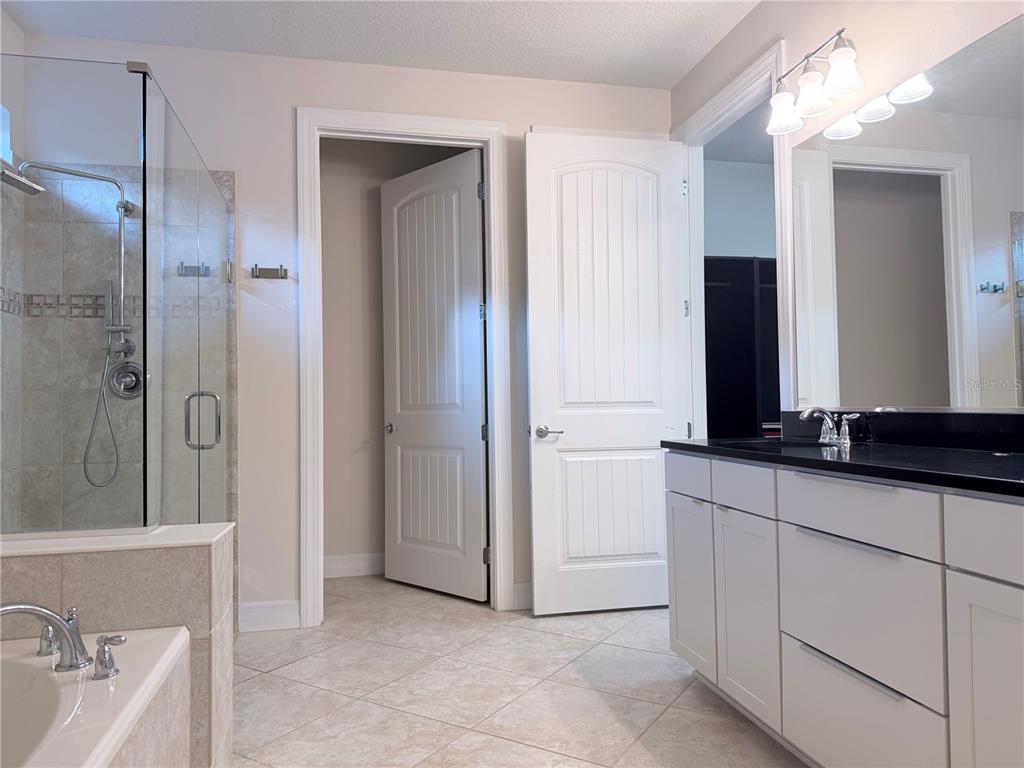10041 Southwest 77th Loop Ocala, FL 34481 - Photo 21 of 39 a bathroom with a double vanity sink and mirror