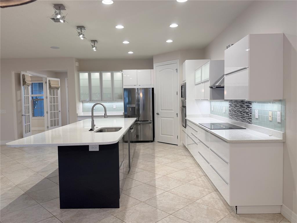 10041 Southwest 77th Loop Ocala, FL 34481 - Photo 4 of 39 a kitchen with stainless steel appliances kitchen island a sink stove and cabinets