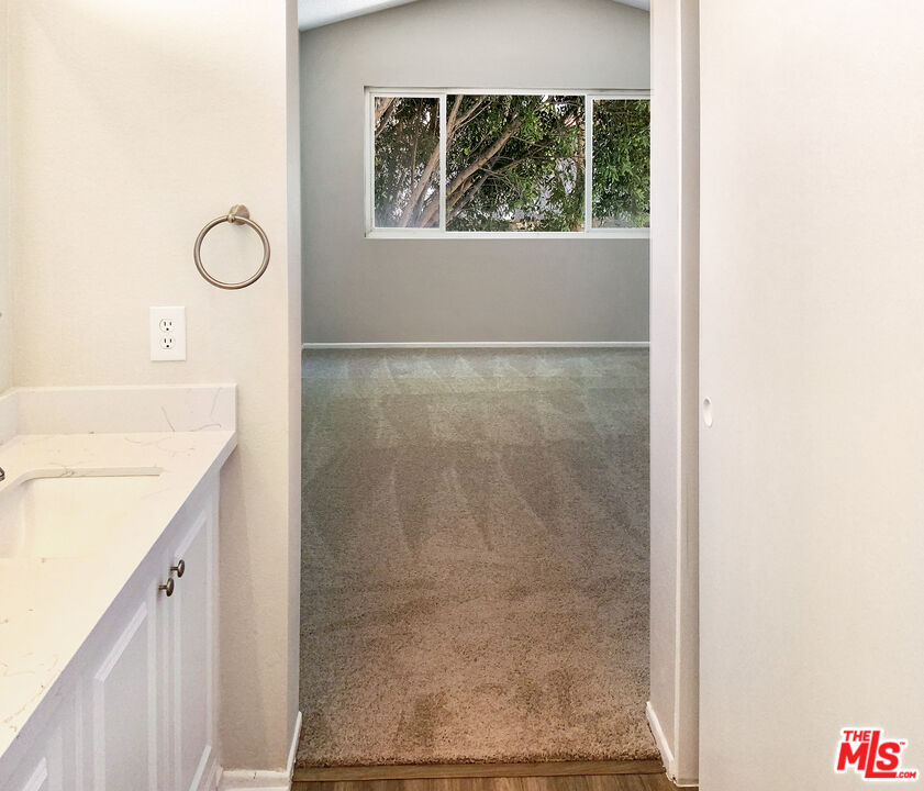 11074 Kenyon Way Rancho Cucamonga, CA 91701 - Photo 23 of 28 a bathroom with a granite countertop sink a mirror and a shower