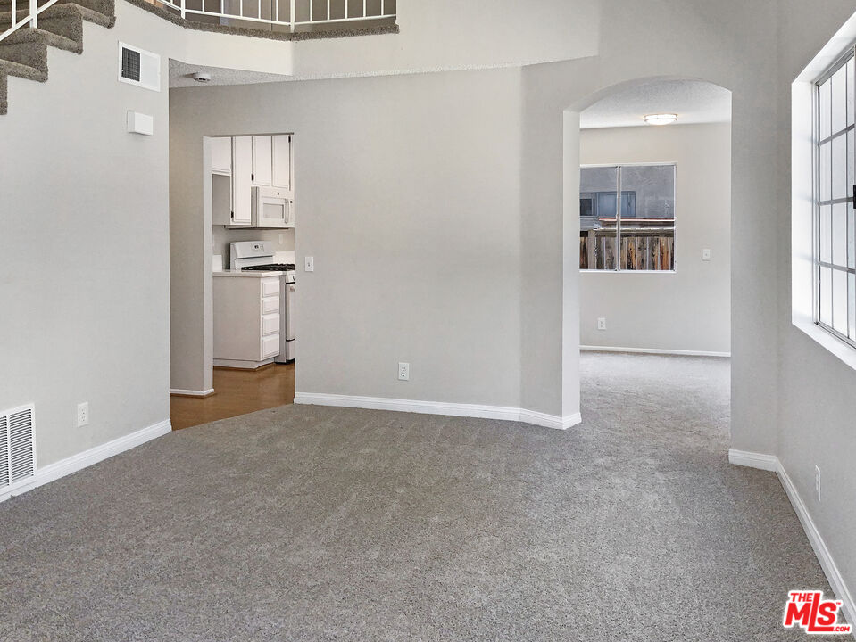 11074 Kenyon Way Rancho Cucamonga, CA 91701 - Photo 3 of 28 an empty room with windows and entrance