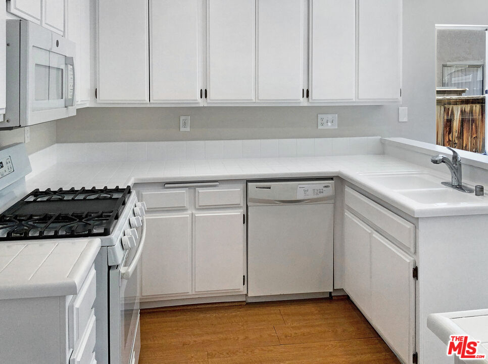 11074 Kenyon Way Rancho Cucamonga, CA 91701 - Photo 6 of 28 a kitchen with a sink and cabinets