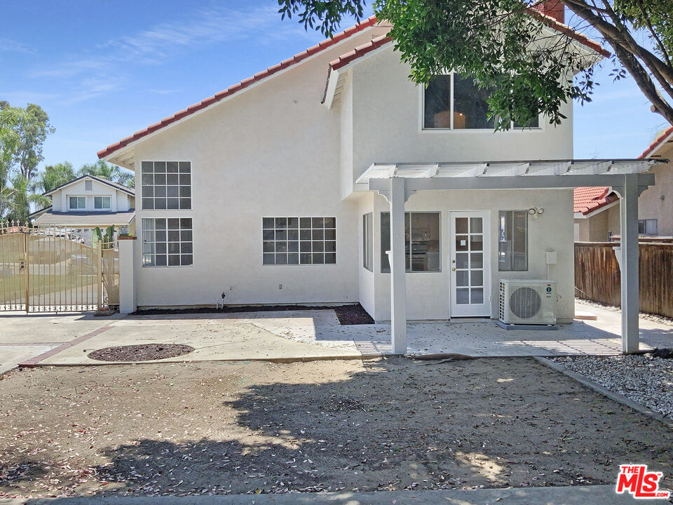 11074 Kenyon Way Rancho Cucamonga, CA 91701 - Photo 8 of 28 a view of a white house with large windows next to a road