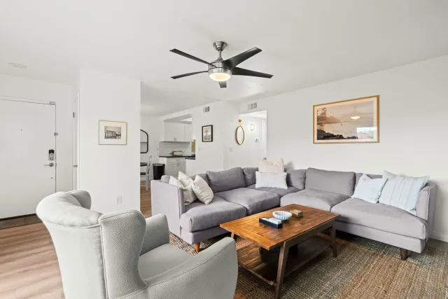 a living room with furniture a rug and a window