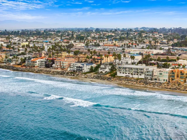 an aerial view of residential building and ocean view