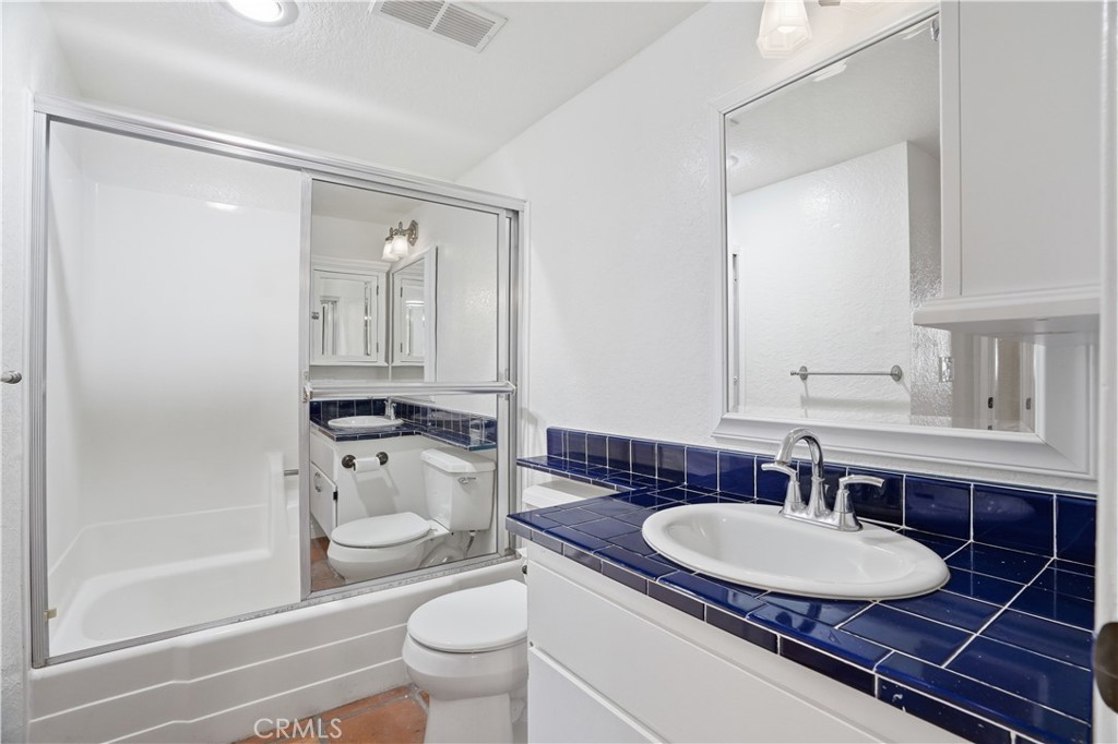 20702 El Toro Road, Unit 231 Lake Forest, CA 92630 - Photo 11 of 36 a bathroom with a sink toilet a mirror and shower