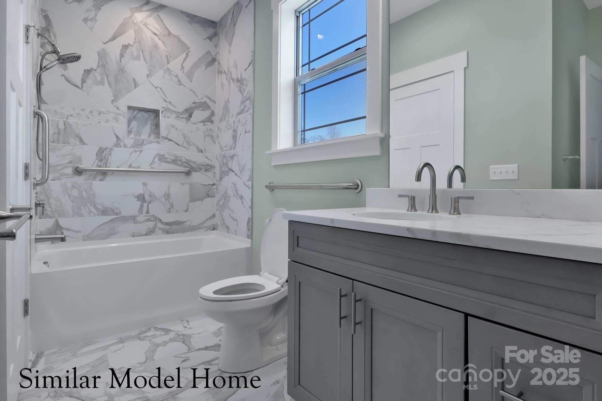 4 Brookstone Place Candler, NC 28715 - Photo 14 of 31 a bathroom with a sink a toilet and a bathtub