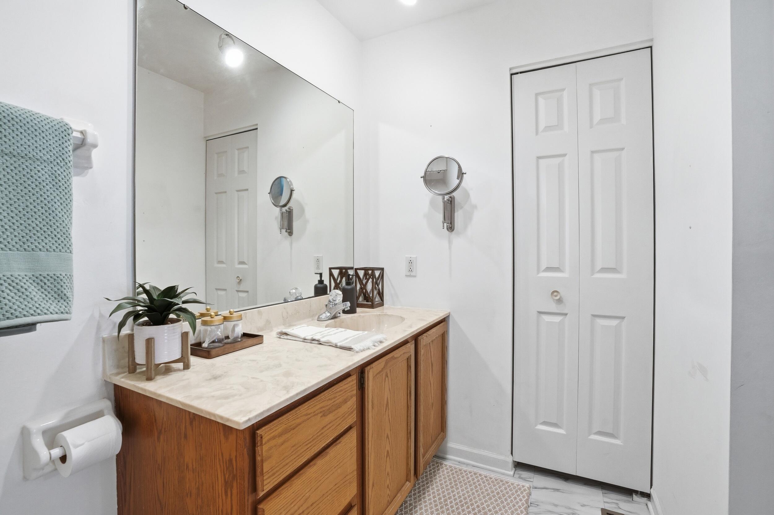 225 Clinton Street Lowell, IN 46356 - Photo 18 of 22 a bathroom with a sink a mirror and a shower