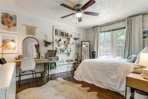 a bedroom with a bed a large window and furniture