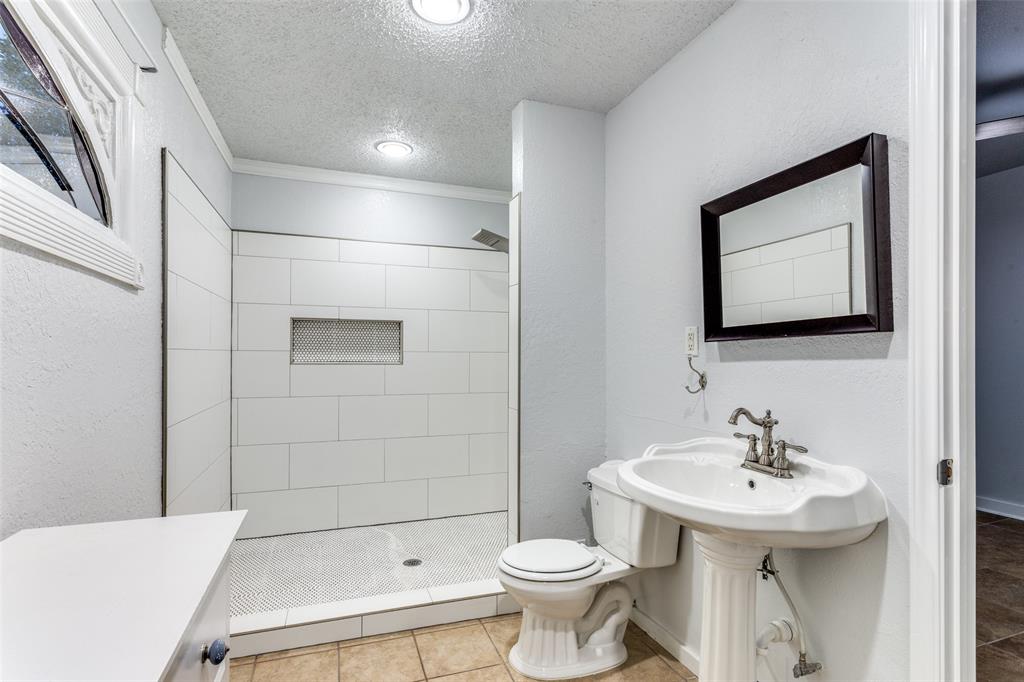 3005 6th Avenue Fort Worth, TX 76110 - Photo 14 of 18 a bathroom with a sink toilet and shower